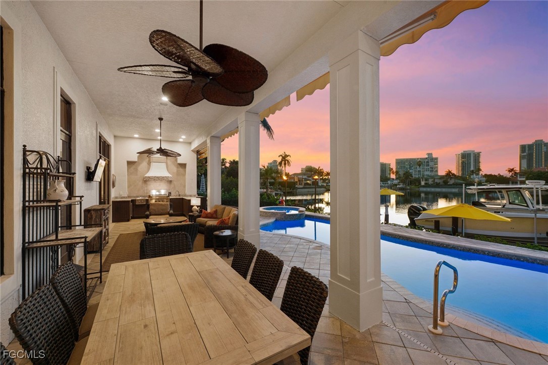 361 Pirates Bight Naples, FL 34103 - Photo 30 of 33 a view of a dining room with furniture a chandelier and wooden floor