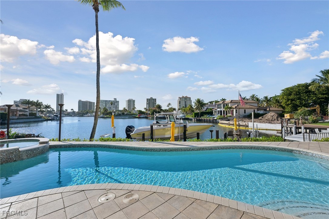 361 Pirates Bight Naples, FL 34103 - Photo 9 of 33 a view of a swimming pool with a lawn chairs