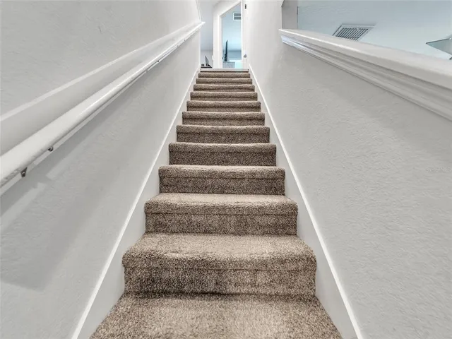 a living room with furniture and a ceiling fan