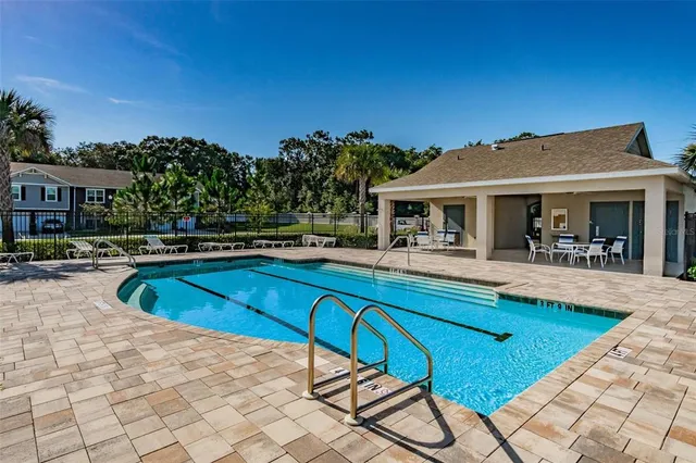 a picture of a living room with a white table and chairs