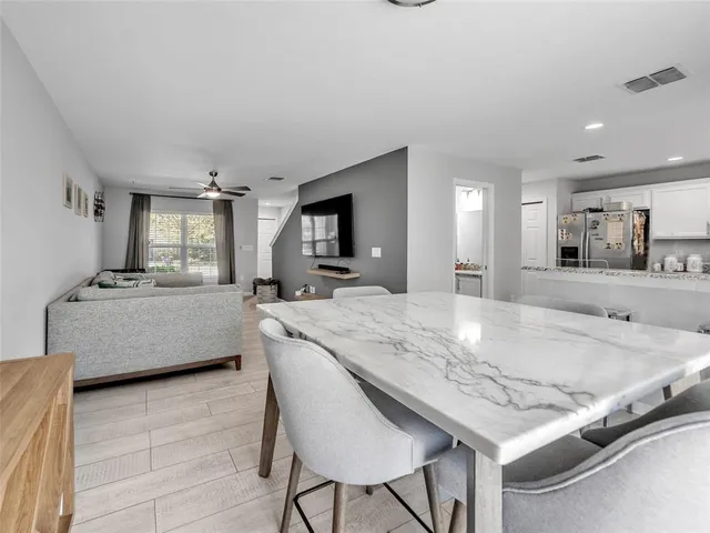 a kitchen with stainless steel appliances granite countertop a stove a sink a microwave and a refrigerator