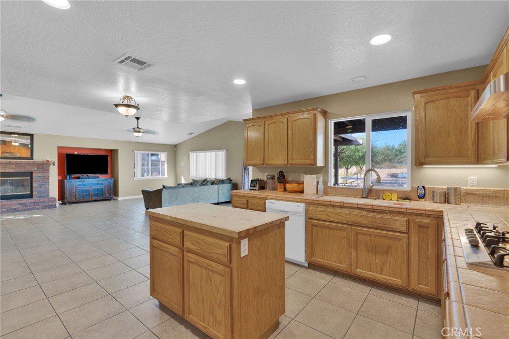 11158 Pinon Avenue Hesperia, CA 92345 - Photo 11 of 39 a kitchen with a sink a counter top space and appliances