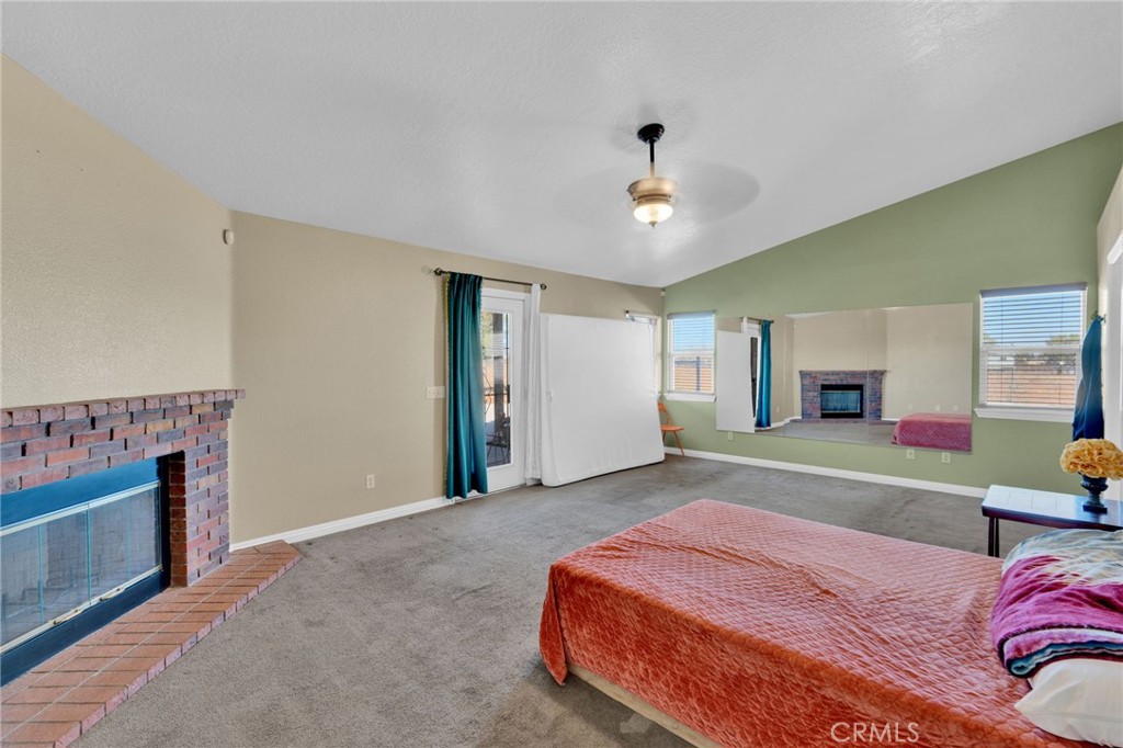 11158 Pinon Avenue Hesperia, CA 92345 - Photo 14 of 39 a spacious bedroom with a bed and a fireplace