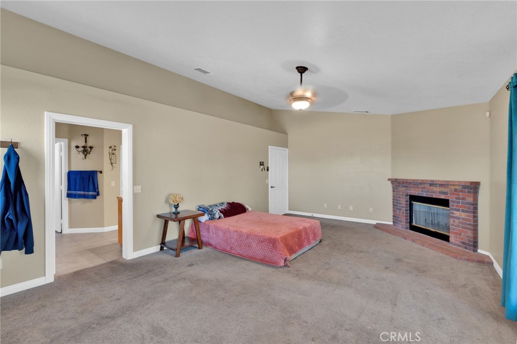 11158 Pinon Avenue Hesperia, CA 92345 - Photo 15 of 39 a spacious bedroom with a bed and a chandelier