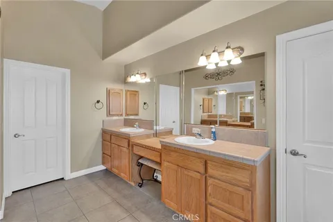 a bathroom with a double vanity sink and a mirror