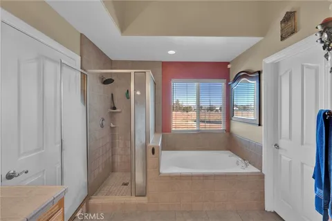 a bathroom with a tub shower vanity and a sink
