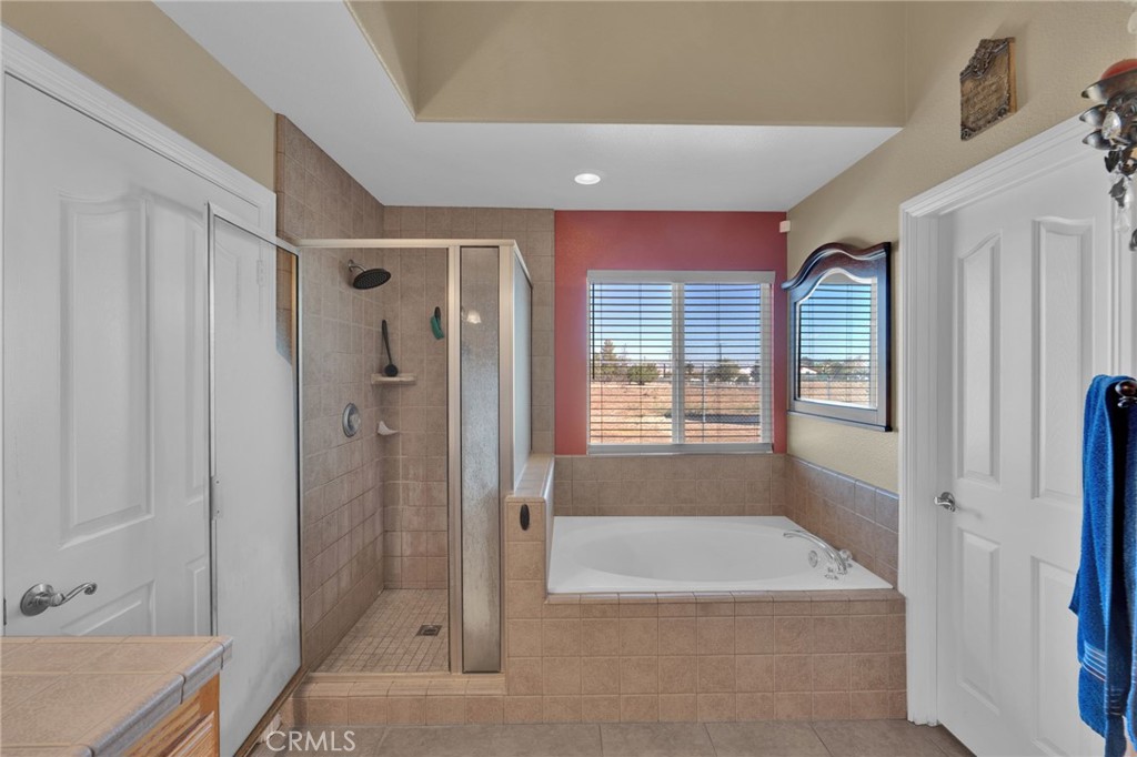 11158 Pinon Avenue Hesperia, CA 92345 - Photo 17 of 39 a bathroom with a tub shower vanity and a sink