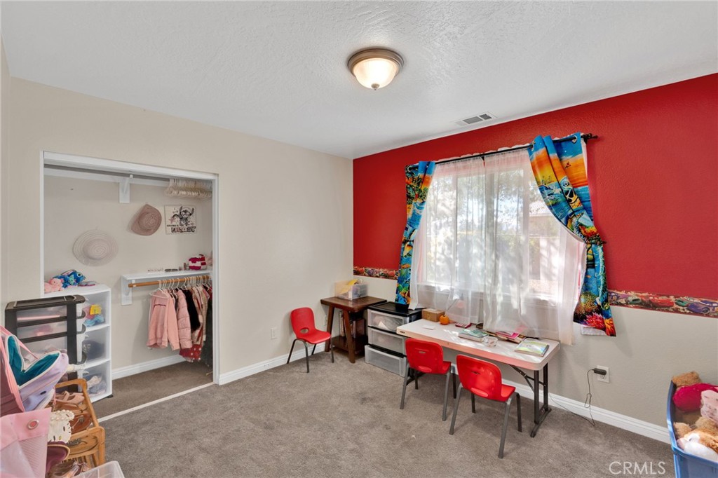 11158 Pinon Avenue Hesperia, CA 92345 - Photo 18 of 39 a living room with furniture and a flat screen tv