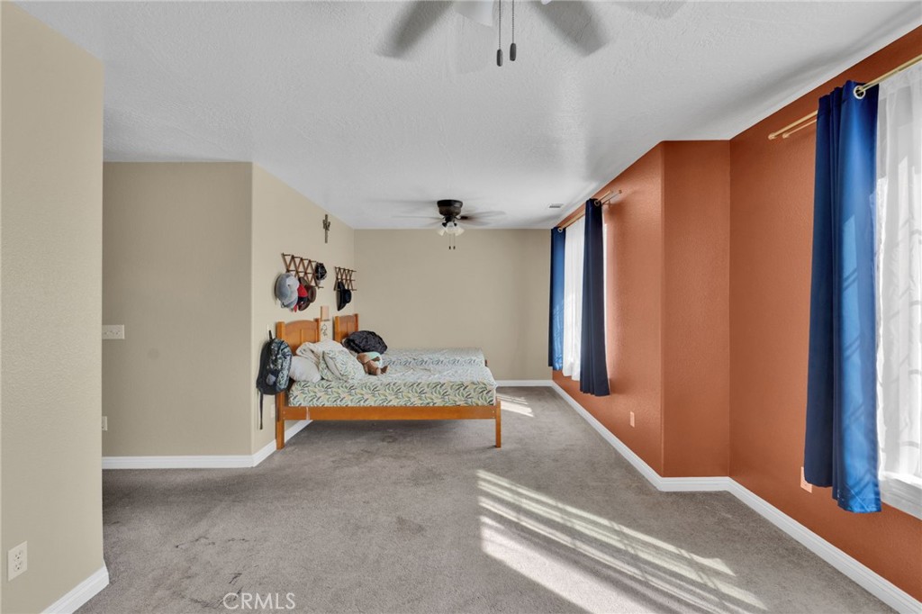 11158 Pinon Avenue Hesperia, CA 92345 - Photo 20 of 39 a bed room with furniture and a window