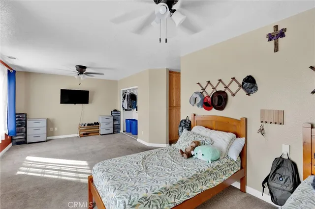 a bedroom with a bed and a couch