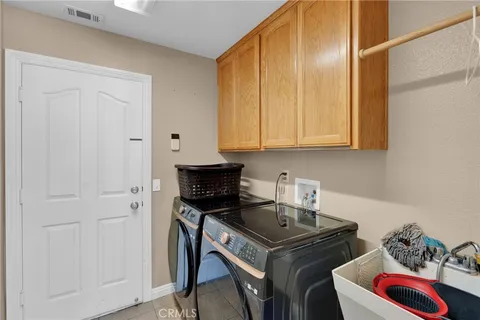 a kitchen with stainless steel appliances a stove a chimney and cabinets