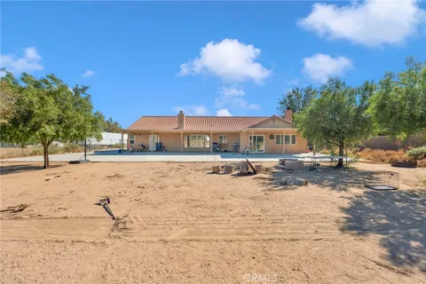 a view of the house with snow on the road
