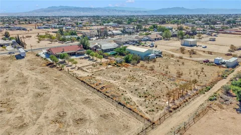 an aerial view of a house with a yard and lake view