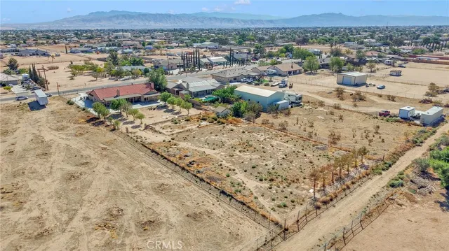 an aerial view of a house with a yard and lake view