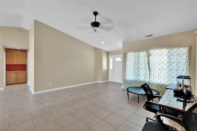 a view of a livingroom with workspace and a window