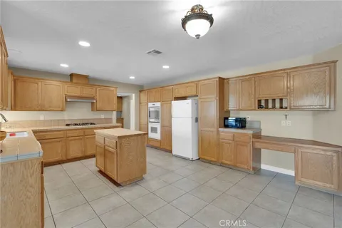 a kitchen with cabinets and refrigerator
