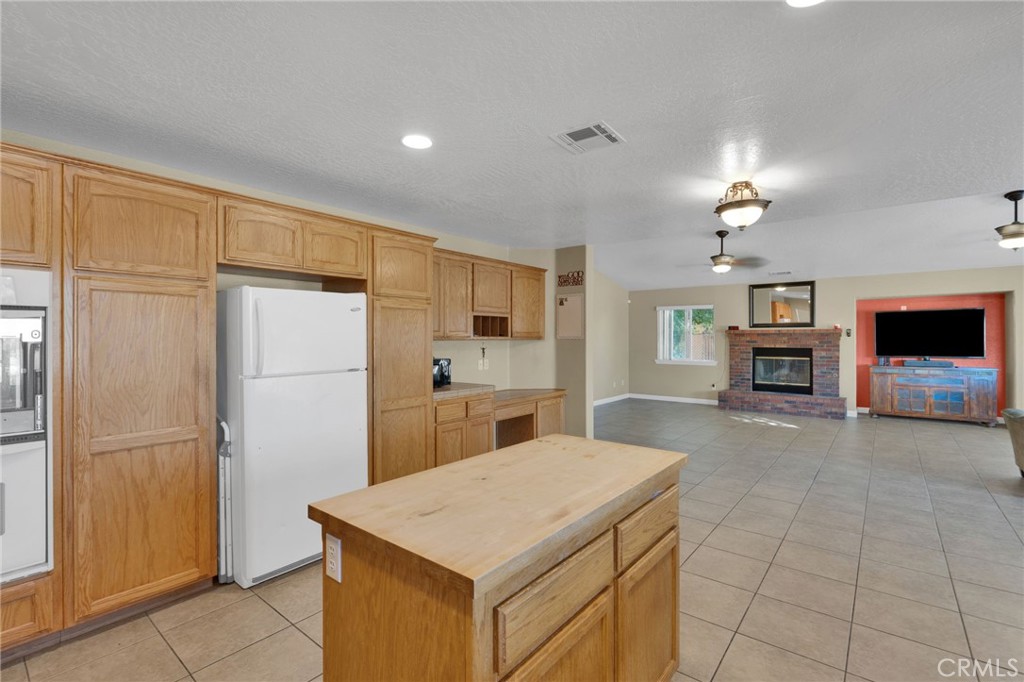 11158 Pinon Avenue Hesperia, CA 92345 - Photo 10 of 39 a kitchen with cabinets and refrigerator