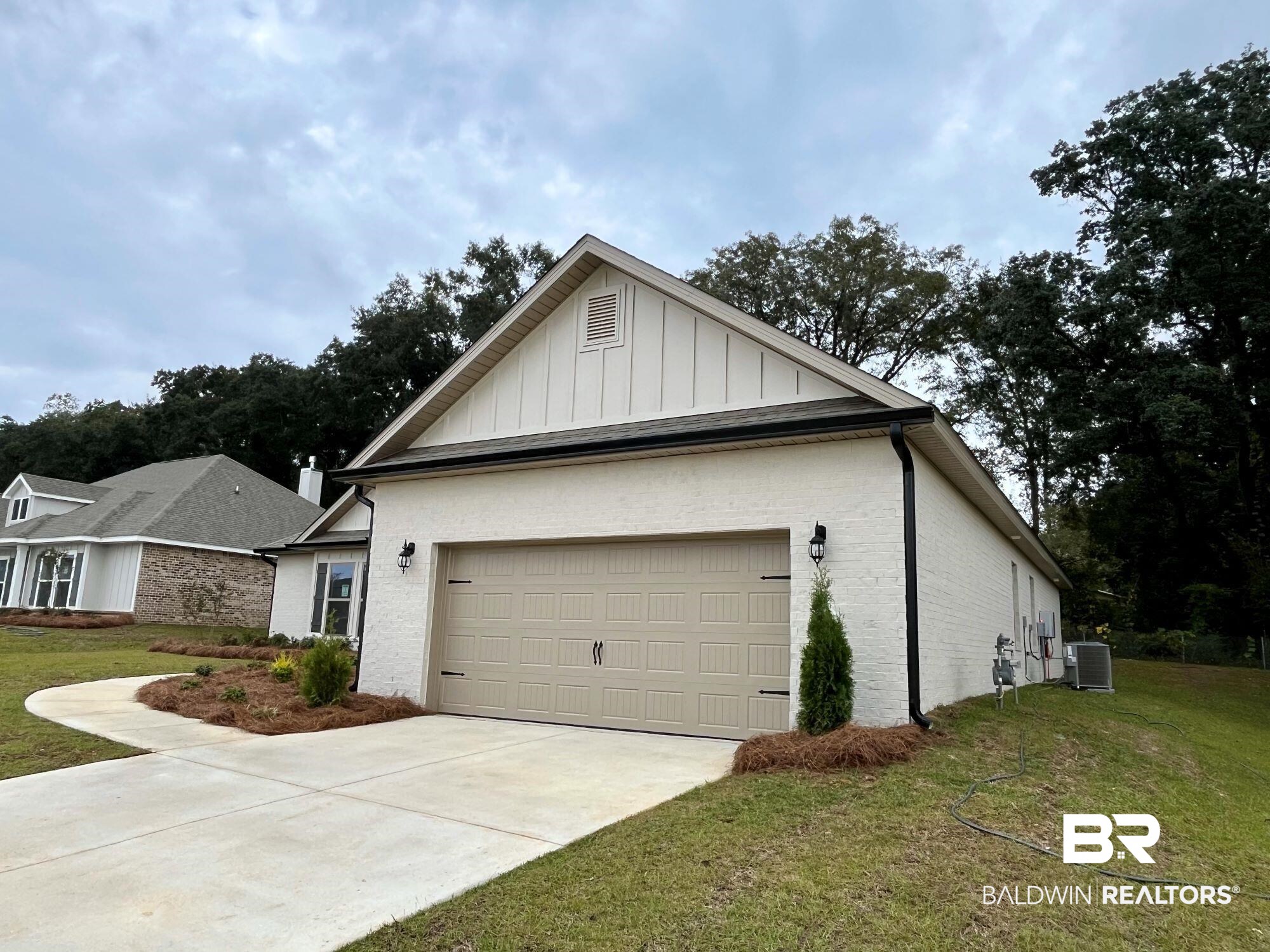 330 Barndling Street Fairhope, AL 36532 - Photo 3 of 31 View of front of house with central air condition unit, a garage, and a front lawn