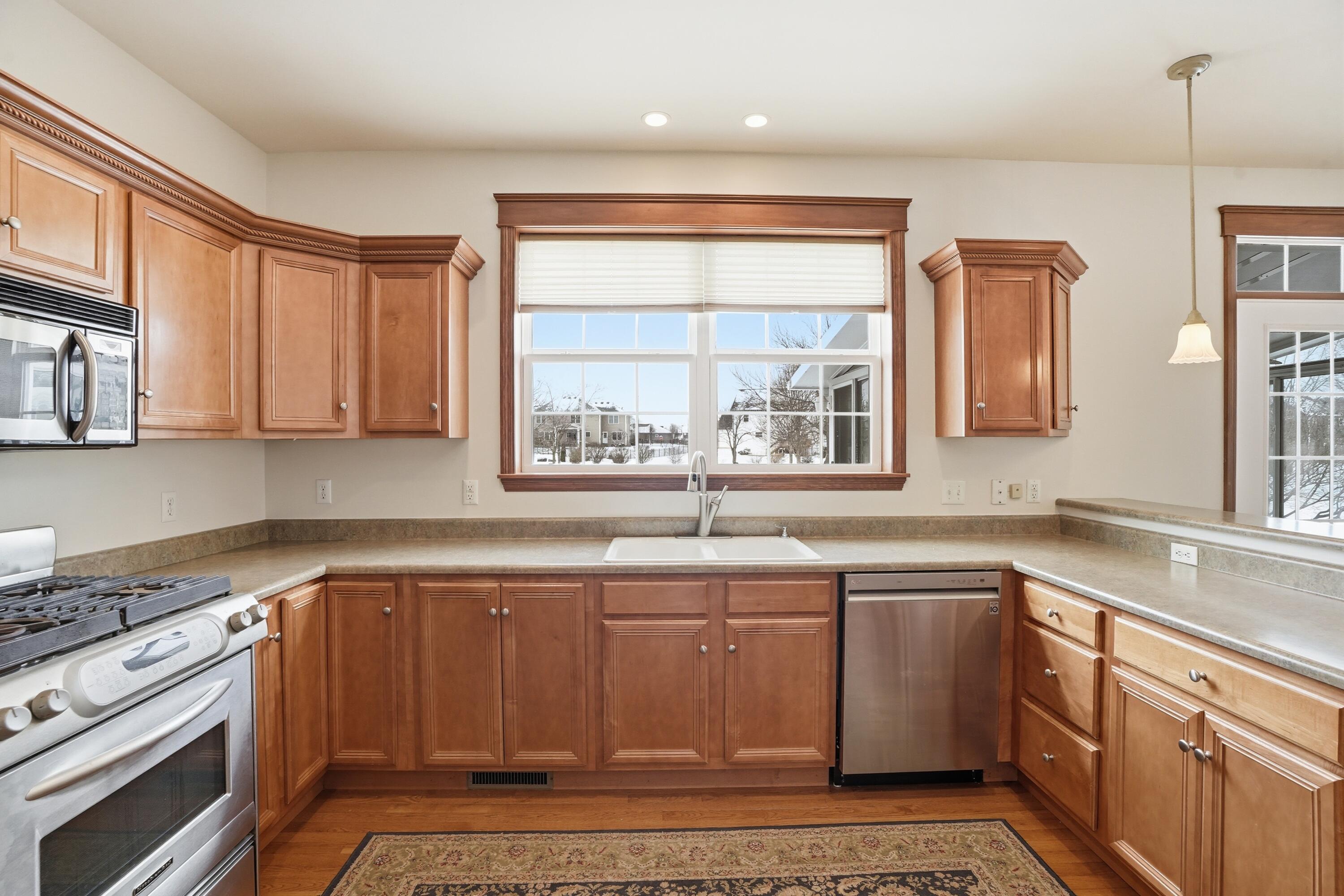 1144 Mary Ellen Drive Crown Point, IN 46307 - Photo 15 of 47 a kitchen with stainless steel appliances granite countertop a sink stove and cabinets
