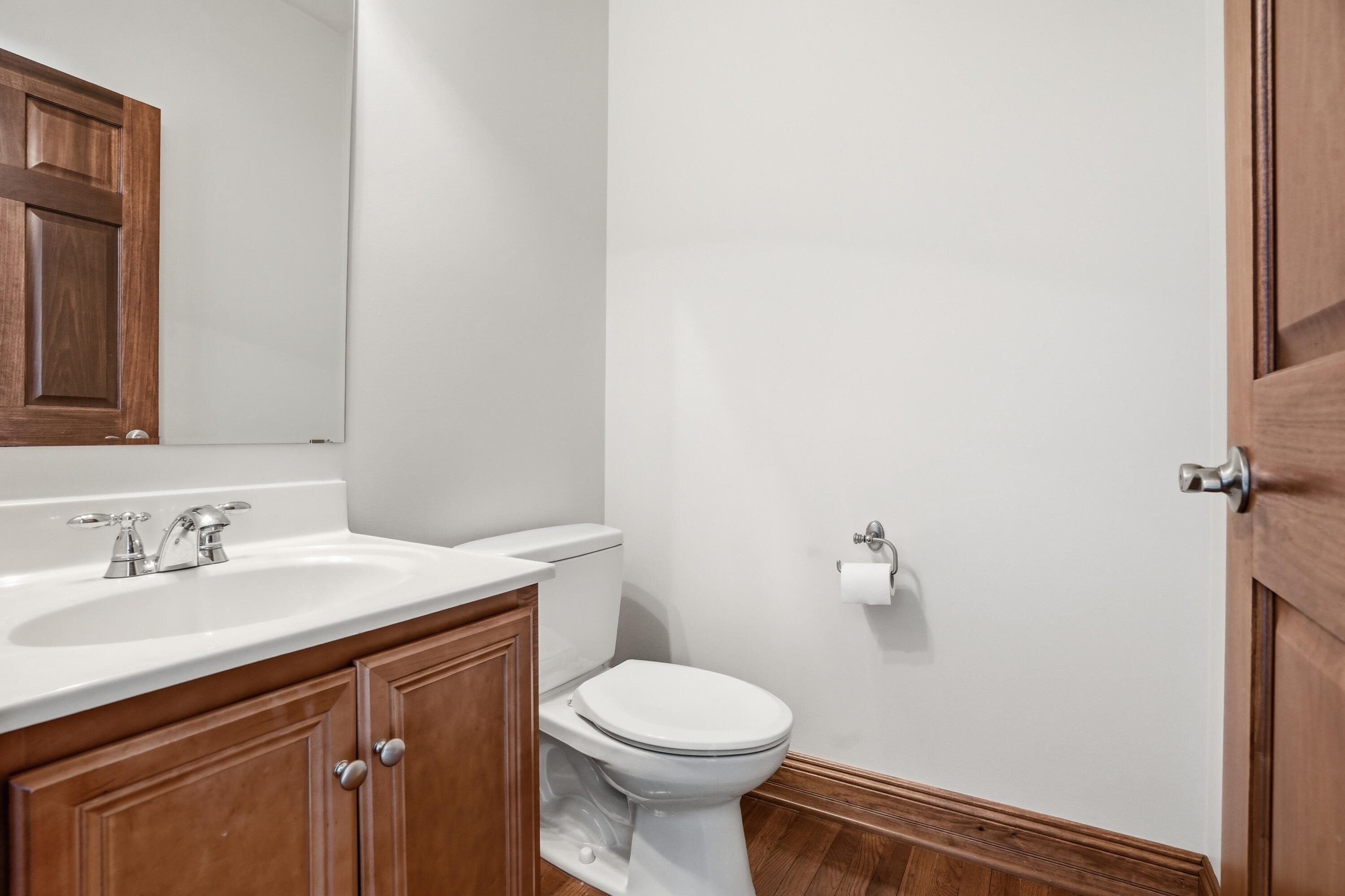 1144 Mary Ellen Drive Crown Point, IN 46307 - Photo 19 of 47 a bathroom with a sink a toilet and a mirror