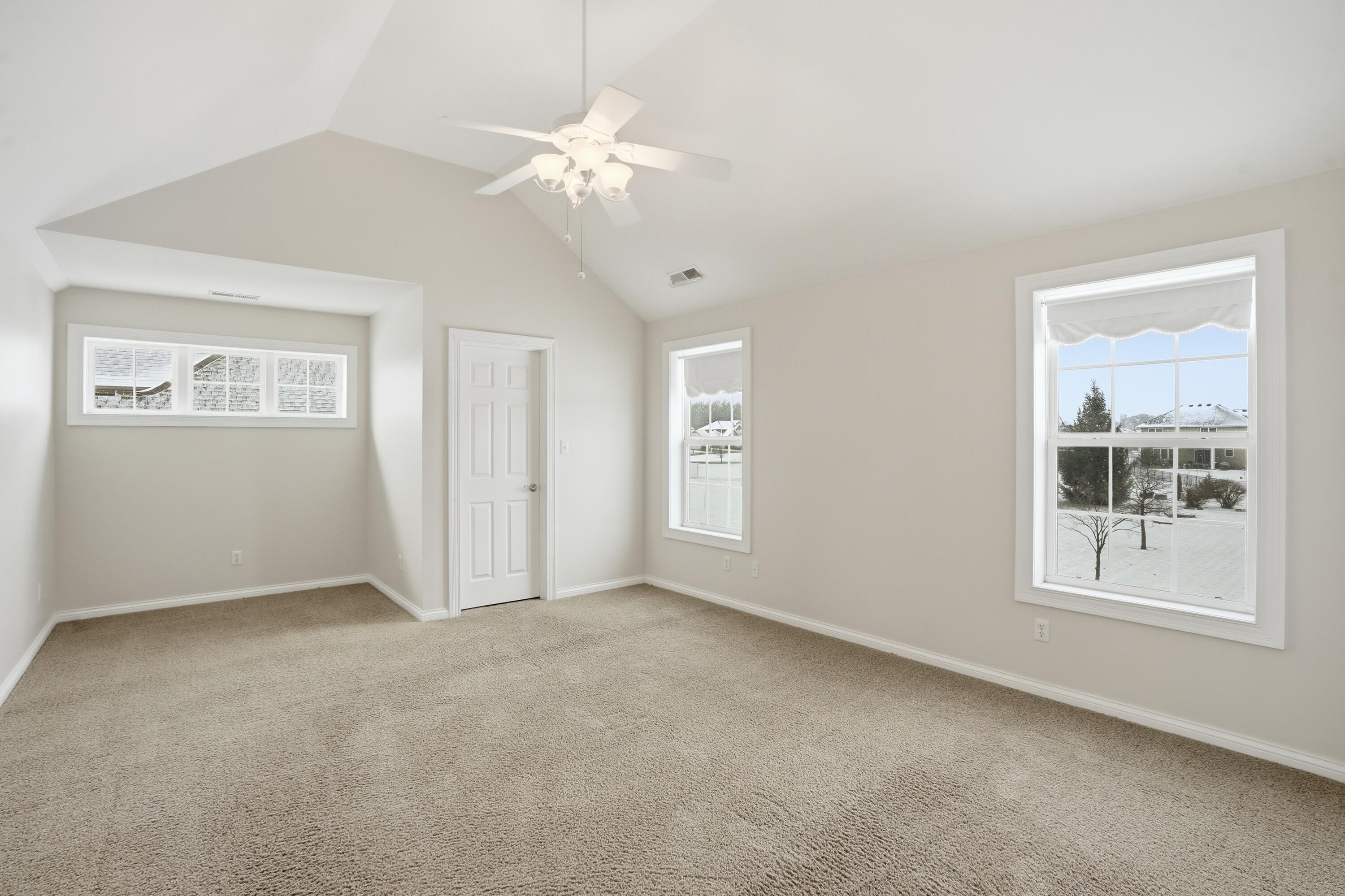 1144 Mary Ellen Drive Crown Point, IN 46307 - Photo 21 of 47 an empty room with windows and chandelier fan