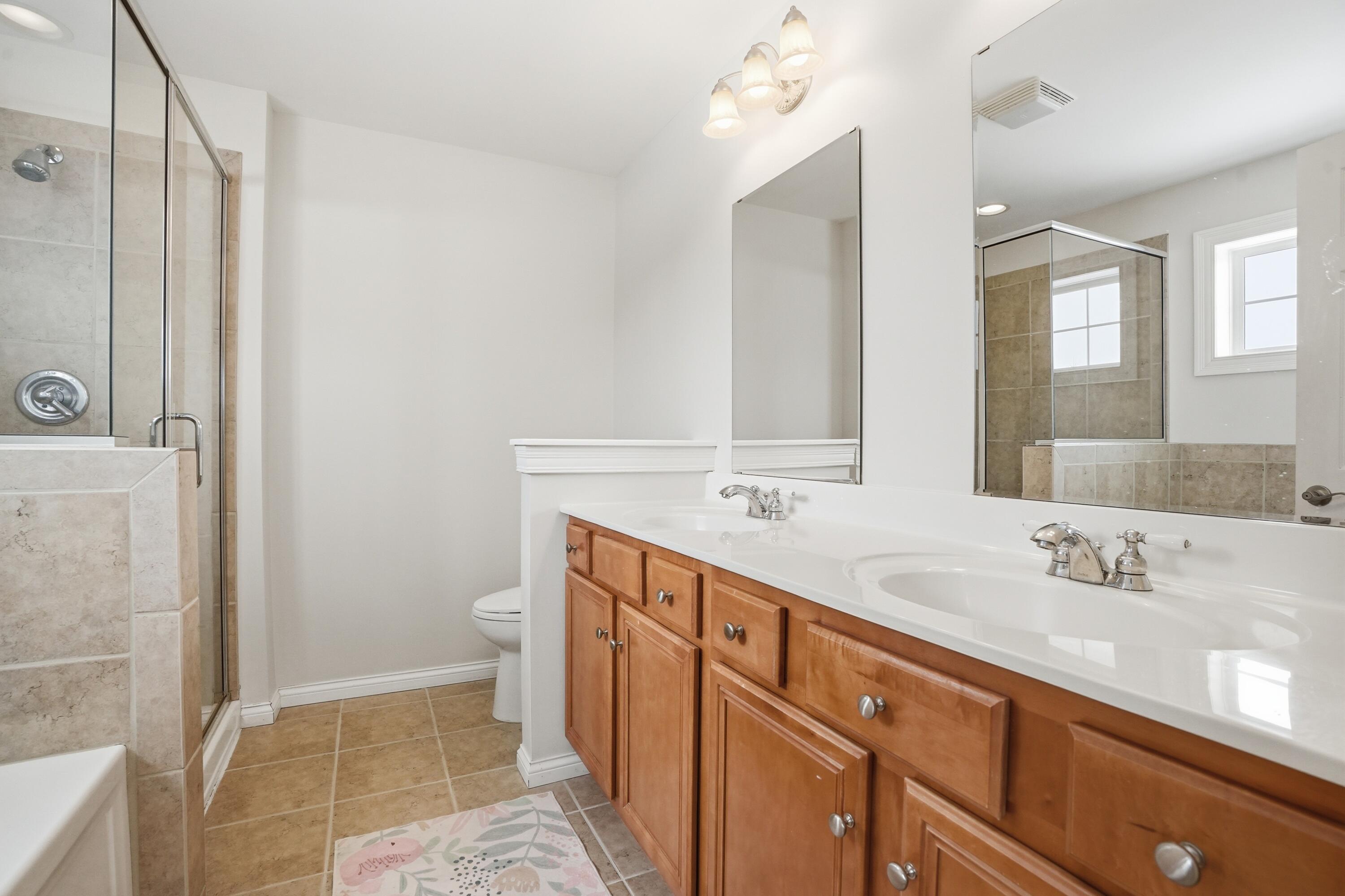 1144 Mary Ellen Drive Crown Point, IN 46307 - Photo 23 of 47 a spacious bathroom with a double vanity sink mirror and toilet