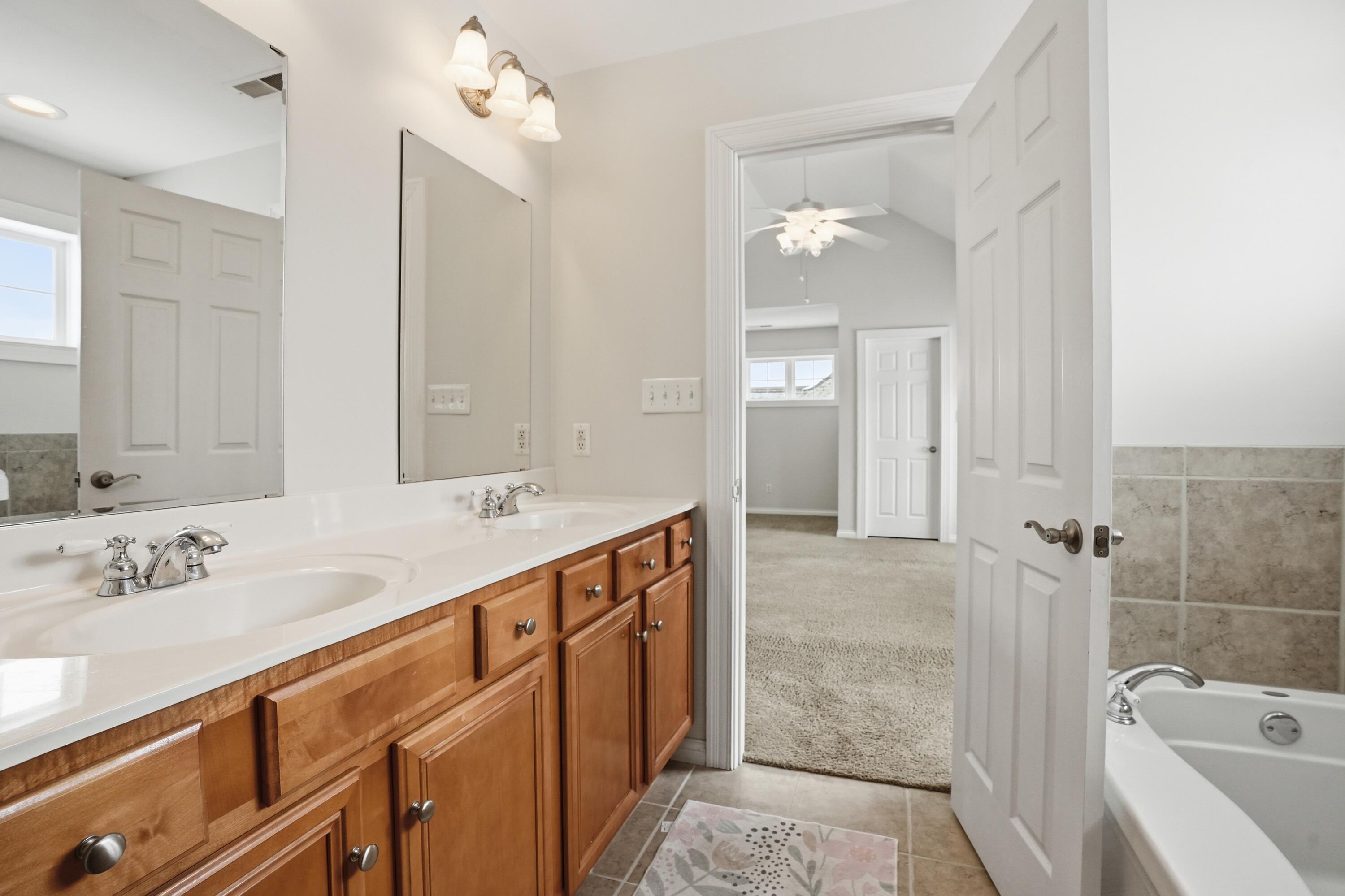 1144 Mary Ellen Drive Crown Point, IN 46307 - Photo 24 of 47 a bathroom with a sink tub and a mirror