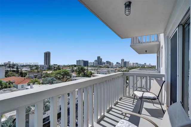a view of a balcony with wooden chairs