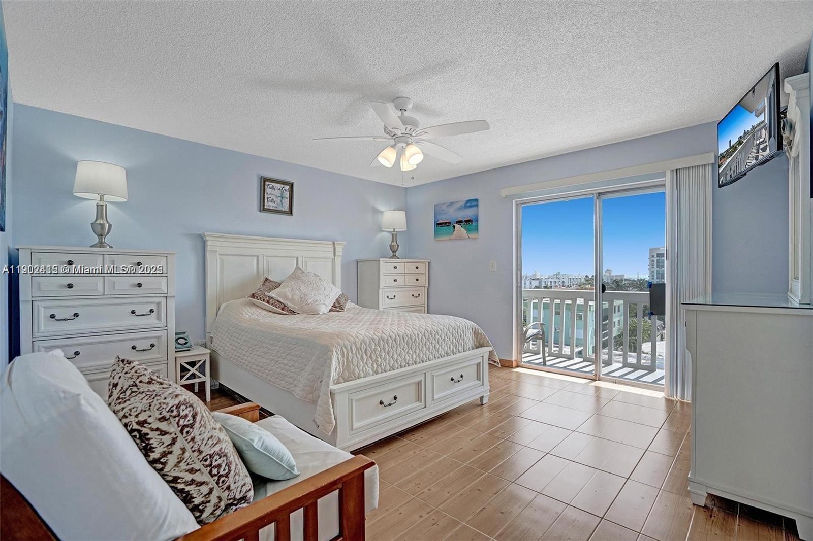7620 Carlyle Avenue, Unit 703 Miami Beach, FL 33141 - Photo 17 of 46 a bedroom with a large bed and a window