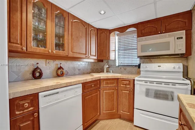 a kitchen with granite countertop cabinets stainless steel appliances and sink