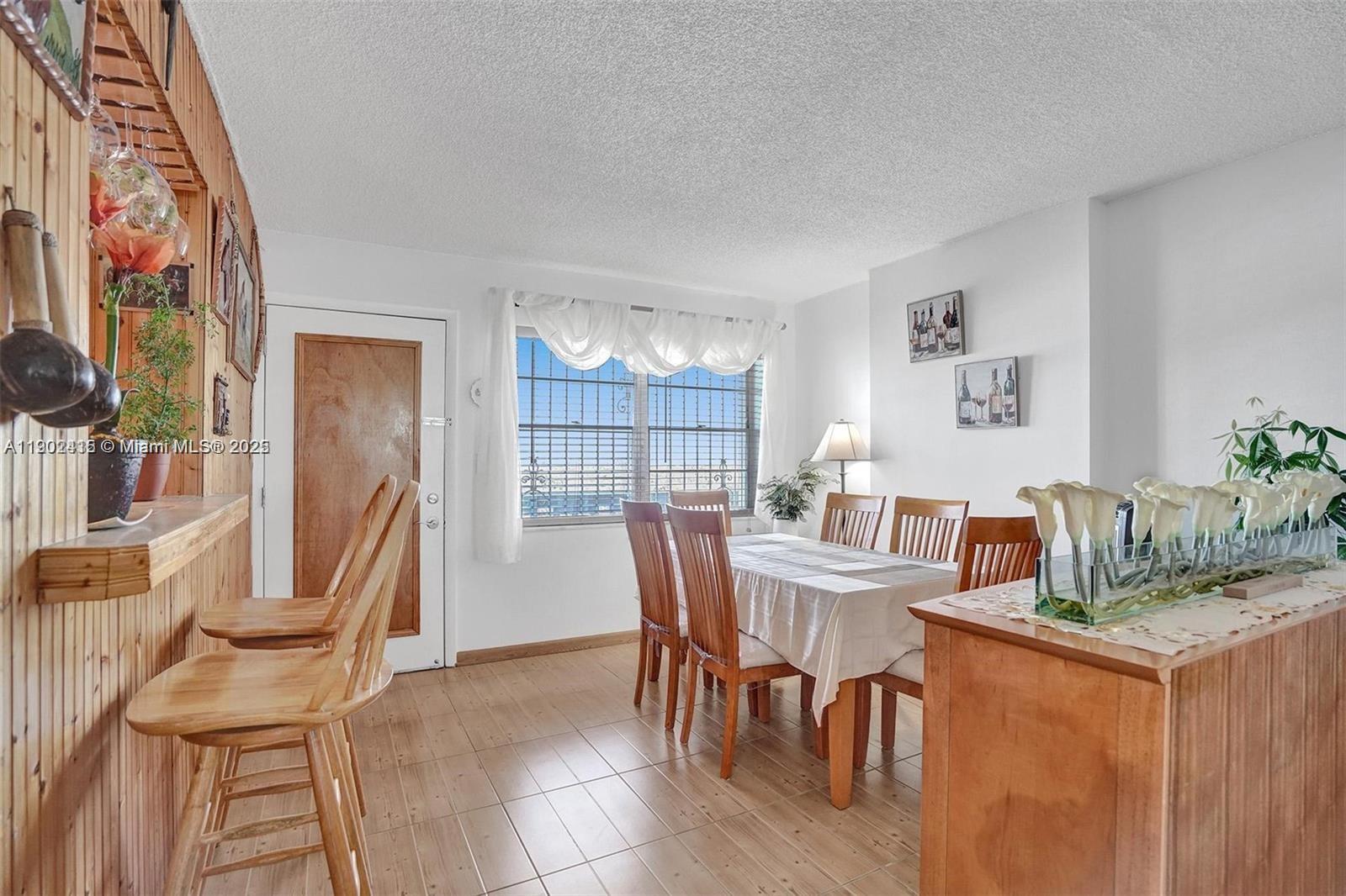 7620 Carlyle Avenue, Unit 703 Miami Beach, FL 33141 - Photo 9 of 46 a dining room with furniture and window