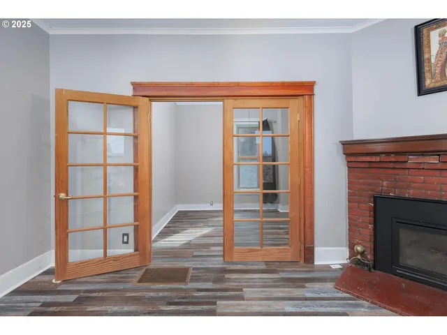 a view of an empty room with wooden floor