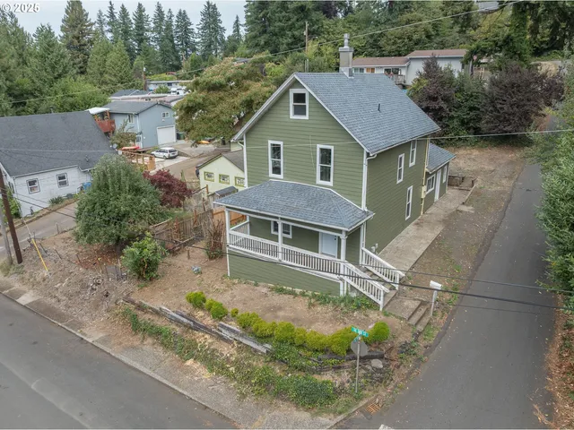 an aerial view of a house with a yard