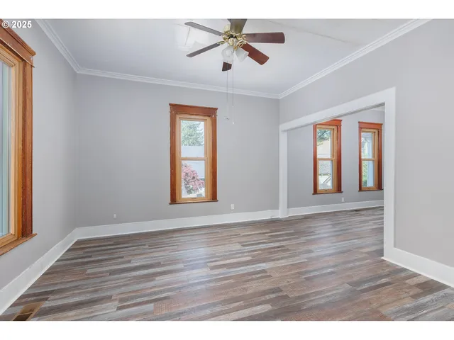 a view of an empty room with wooden floor