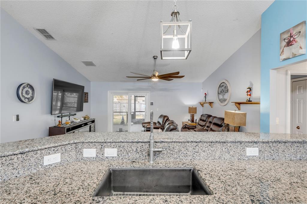 7 Ranbay Place Palm Coast, FL 32164 - Photo 21 of 76 a kitchen with a sink and a refrigerator