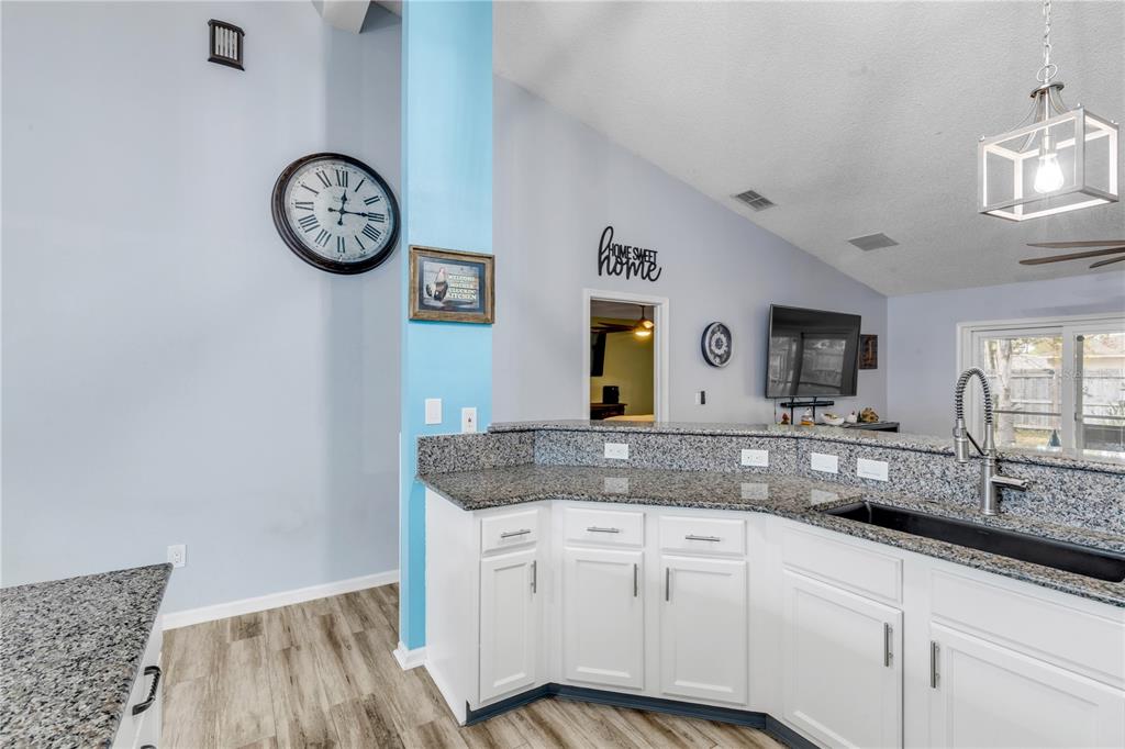 7 Ranbay Place Palm Coast, FL 32164 - Photo 22 of 76 a view of a kitchen with sink and dishwasher stove with wooden floor