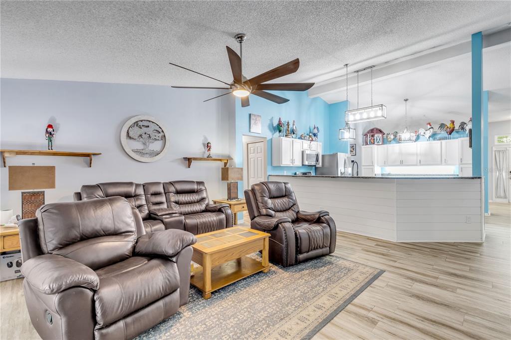 7 Ranbay Place Palm Coast, FL 32164 - Photo 25 of 76 a living room with furniture a clock and a ceiling fan