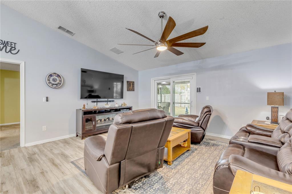 7 Ranbay Place Palm Coast, FL 32164 - Photo 26 of 76 a living room with furniture and a flat screen tv