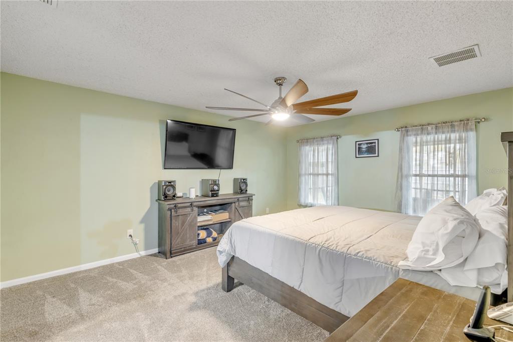 7 Ranbay Place Palm Coast, FL 32164 - Photo 29 of 76 a bedroom with a bed and a flat screen tv