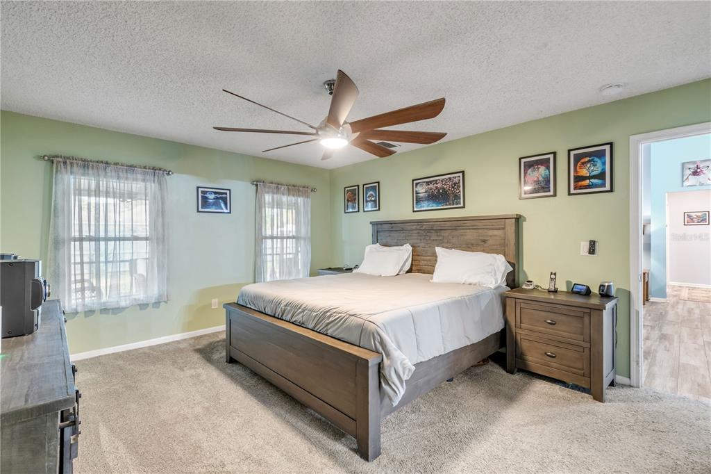 7 Ranbay Place Palm Coast, FL 32164 - Photo 30 of 76 a spacious bedroom with a large bed and a chandelier