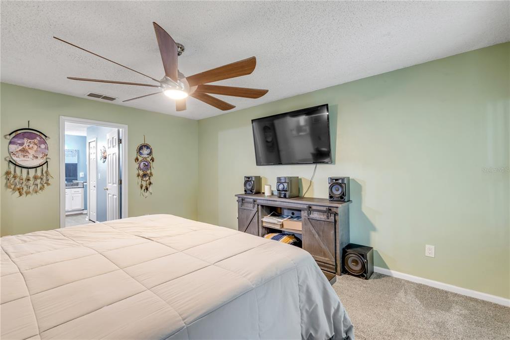 7 Ranbay Place Palm Coast, FL 32164 - Photo 32 of 76 a bedroom with a bed and a flat screen tv