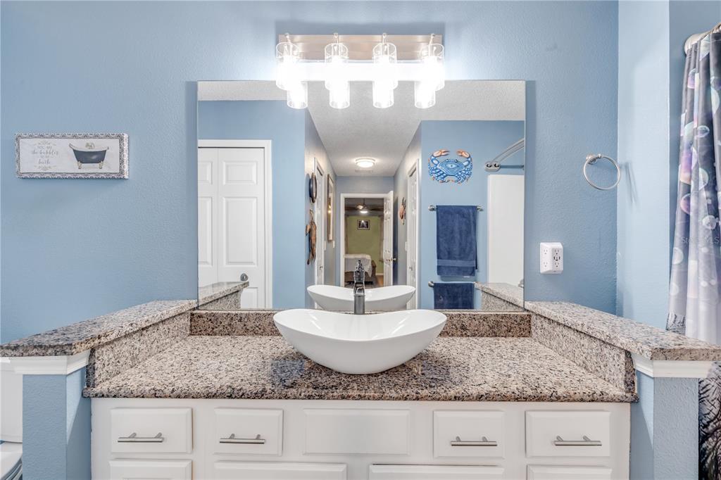 7 Ranbay Place Palm Coast, FL 32164 - Photo 33 of 76 a bathroom with a granite countertop sink and a mirror