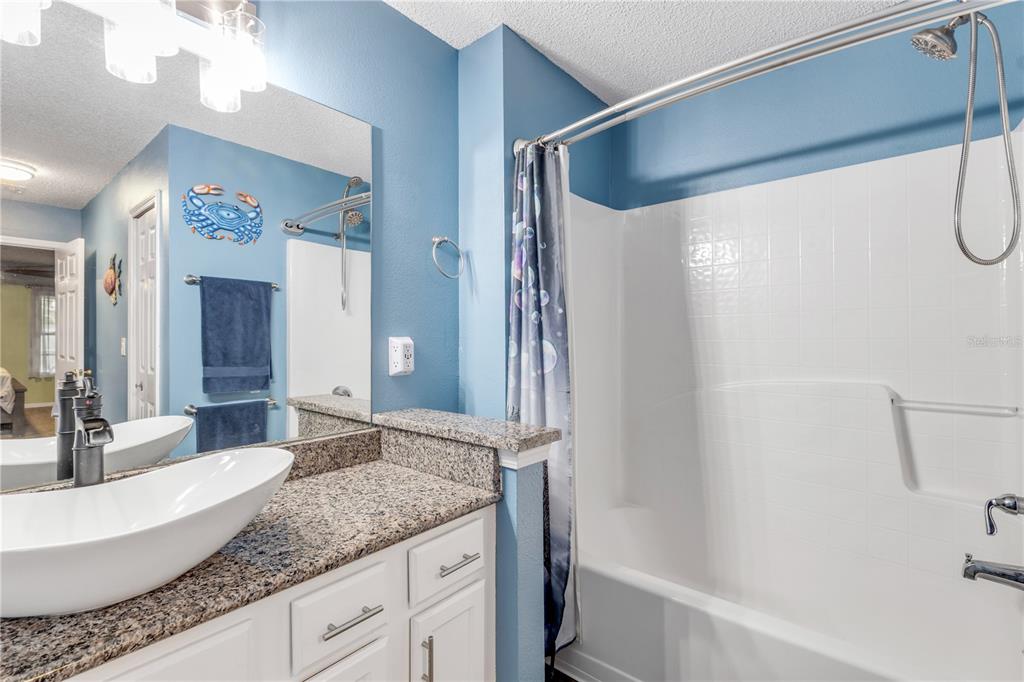 7 Ranbay Place Palm Coast, FL 32164 - Photo 34 of 76 a bathroom with a granite countertop sink mirror and a bathtub