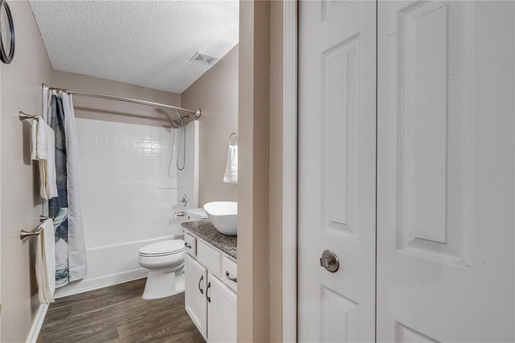 7 Ranbay Place Palm Coast, FL 32164 - Photo 37 of 76 a bathroom with a granite countertop sink a toilet and shower