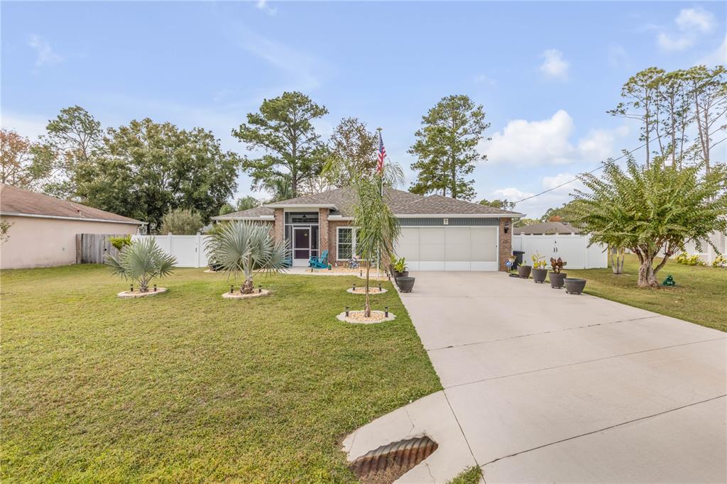 7 Ranbay Place Palm Coast, FL 32164 - Photo 75 of 76 a view of a house with a yard and a garage