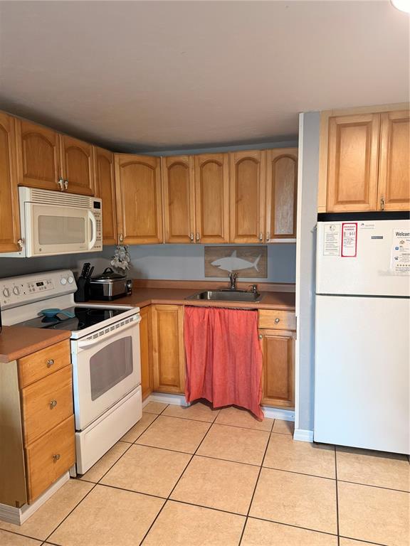 82 2nd Street, Unit D5 Cedar Key, FL 32625 - Photo 4 of 31 a kitchen with stainless steel appliances granite countertop a stove a sink and a refrigerator