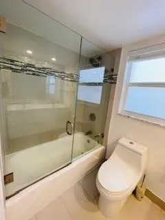 a bathroom with a tub and a shower