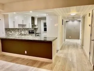 a bathroom with a sink vanity and mirror