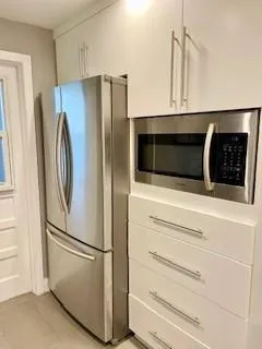 a kitchen with stainless steel appliances a refrigerator and cabinets