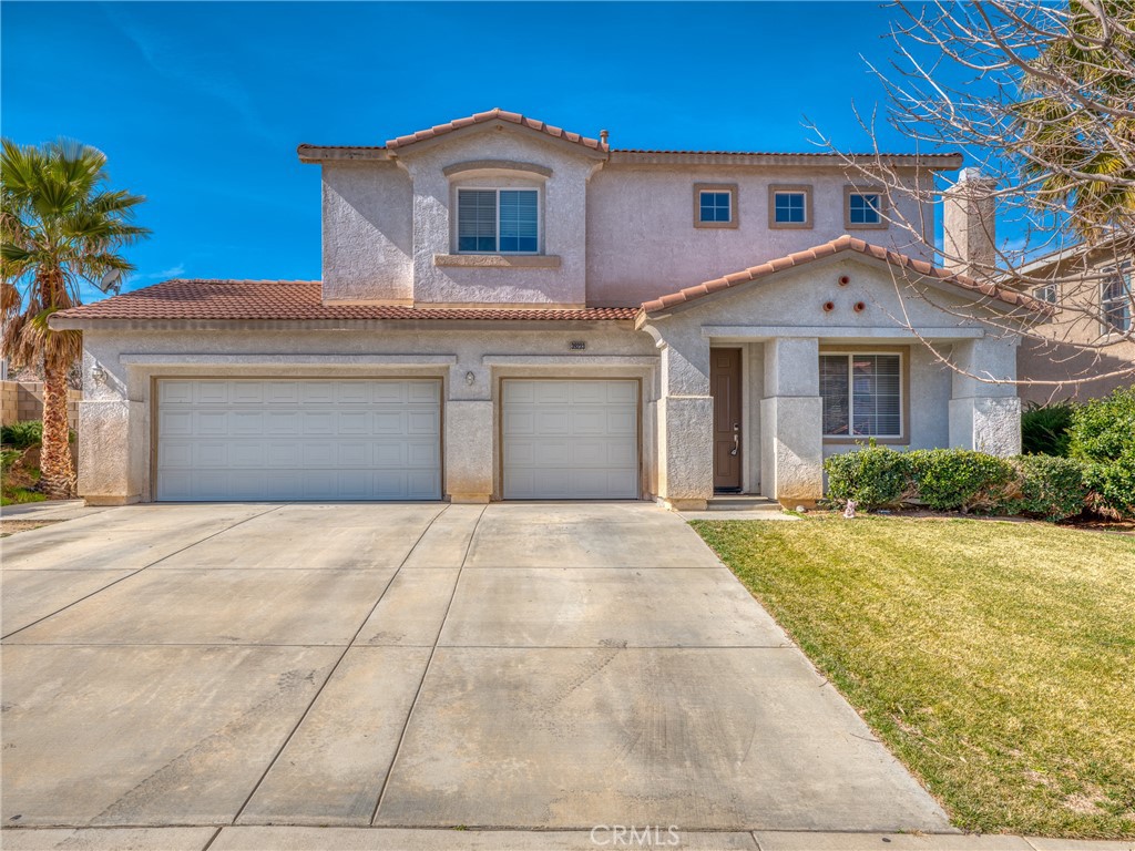 39233 Chantilly Lane Palmdale, CA 93551 - Photo 1 of 31 a front view of a house with a yard and garage